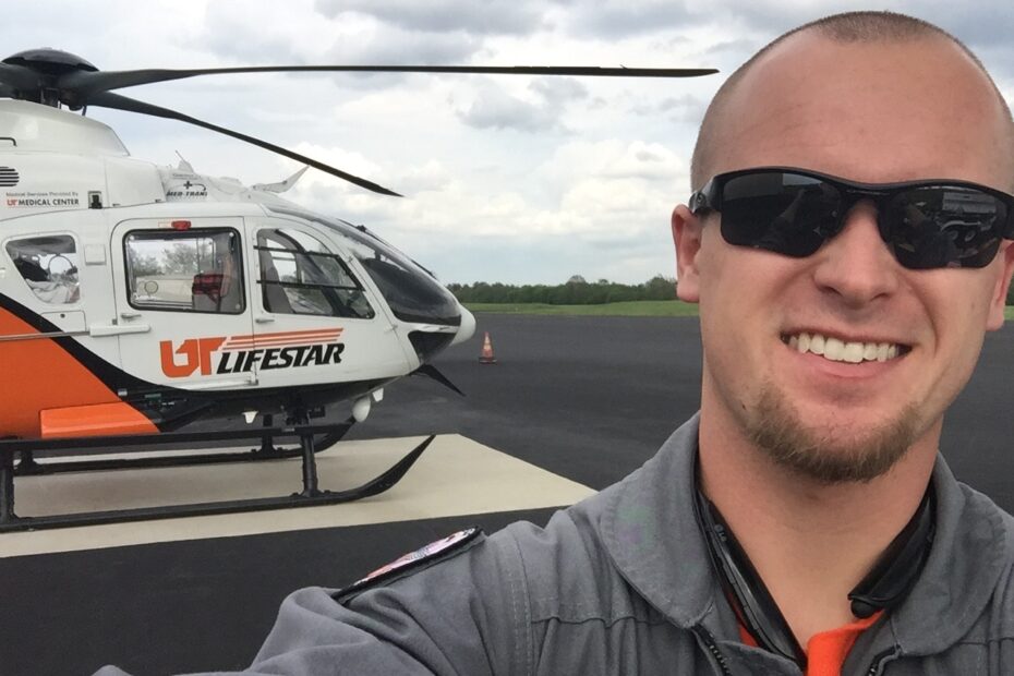 Matthew Plummer in front of UT LIFESTAR helicopter